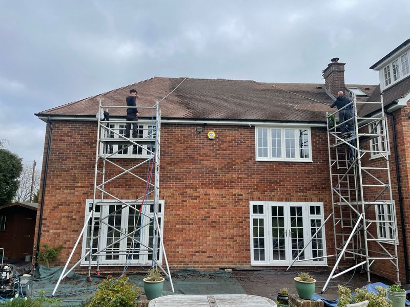 Roof cleaning carried out safely from scaffold towers by The Roof Moss Cleaners in East Horsley